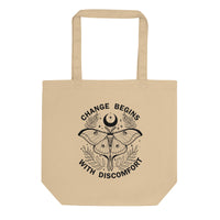 organic tote back in the colour oyster with black print image of a lunar moth and the words change begins with discomfort