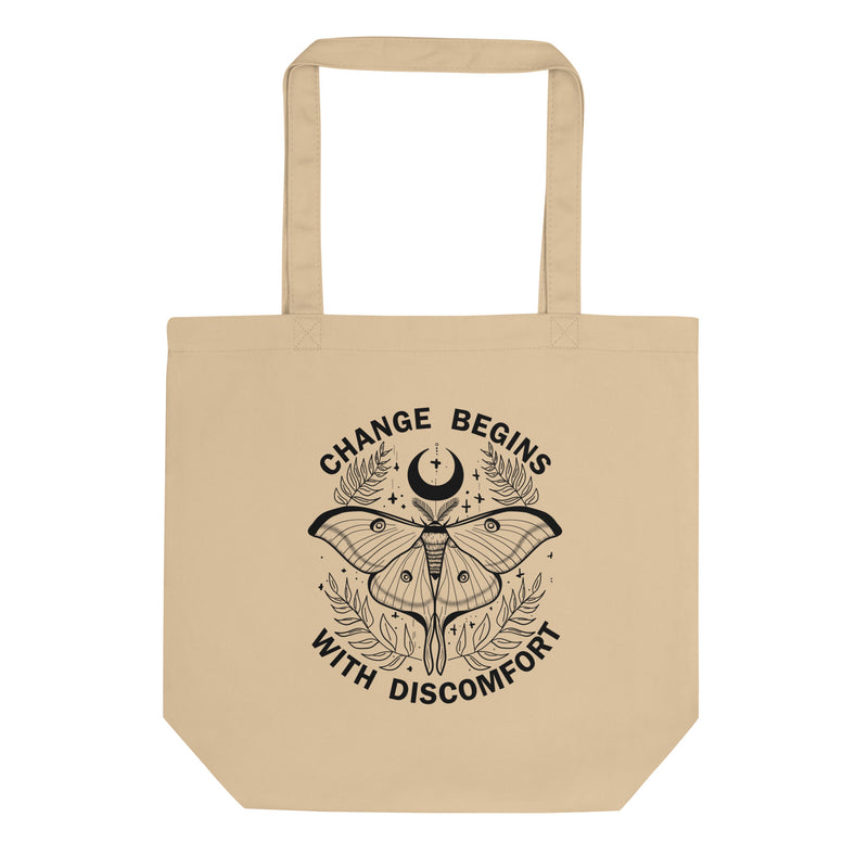 organic tote back in the colour oyster with black print image of a lunar moth and the words change begins with discomfort