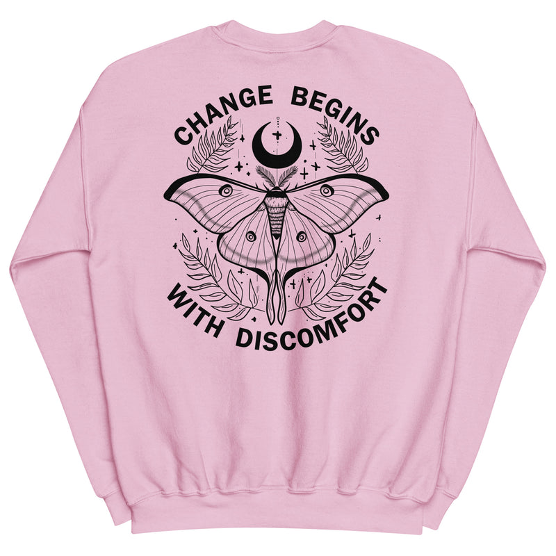 warm unisex sweatshirt in the colour light pinkon the back is a big black print image of a lunar moth and the words change begins with discomfort